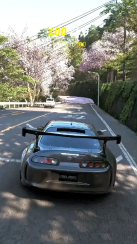 First frame of the analysed post: an in-game sports car drifting down a sunlit mountain road in a photoreal racing game.