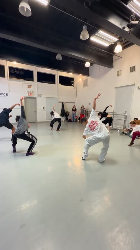 First frame of the analysed post: dancers mid-choreography in a bright studio.